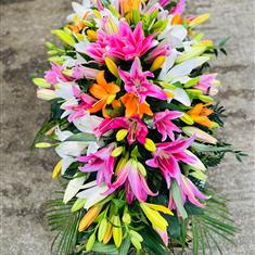 Vibrant lily casket tribute 