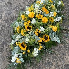 Yellow &amp; white casket including sunflowers